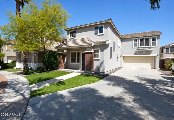 a front view of a house with a yard and garage