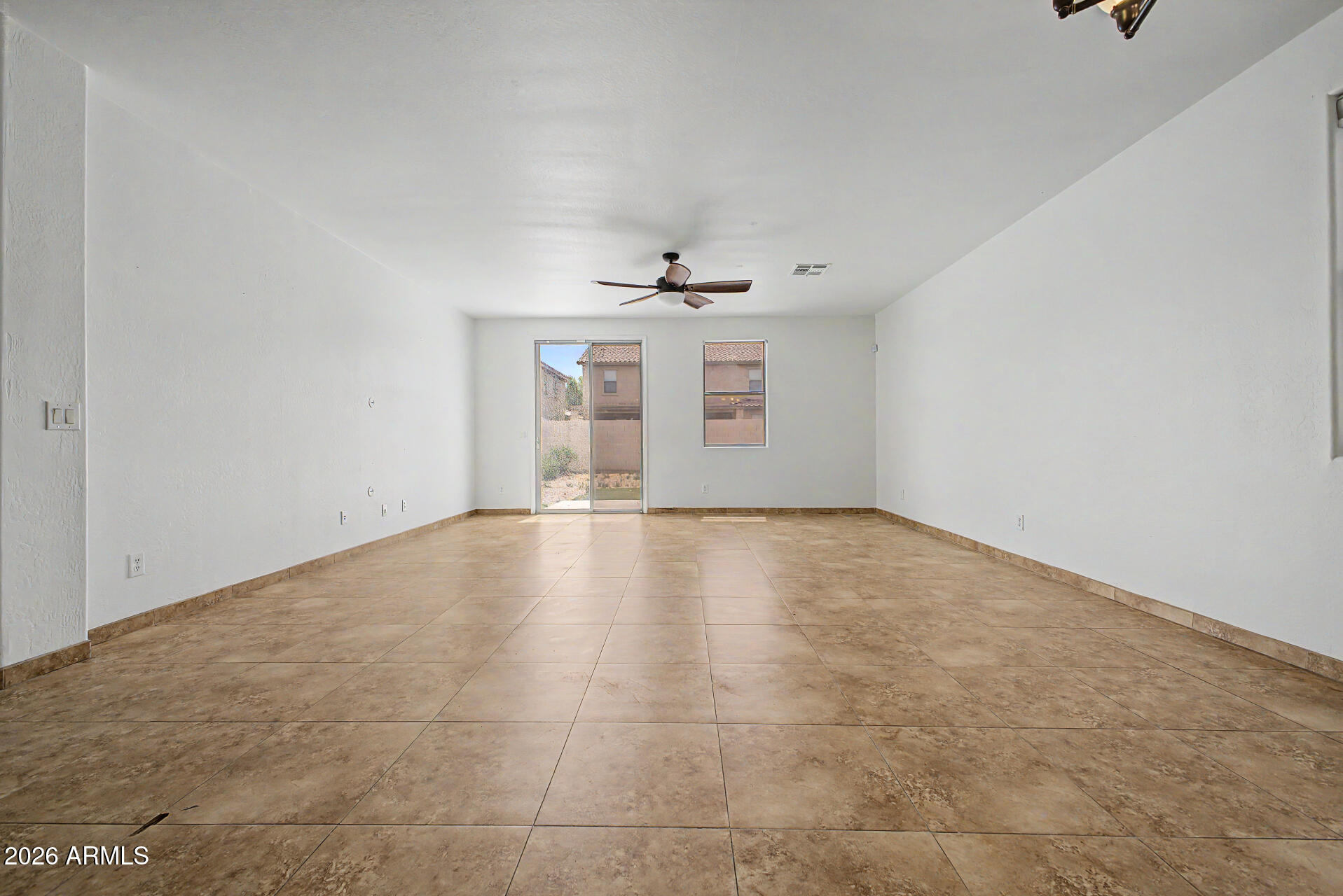 45571 West Tucker Road Maricopa, AZ 85139 - Photo 13 of 61 an empty room with a window and a ceiling fan