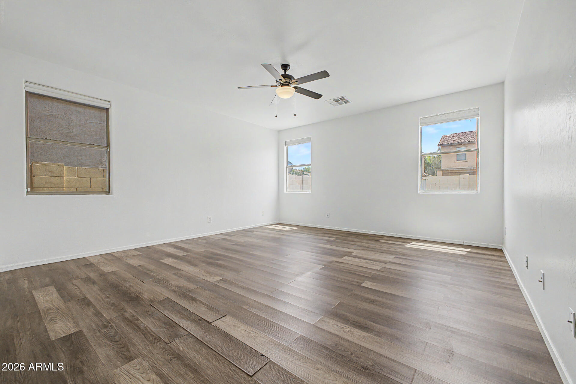 45571 West Tucker Road Maricopa, AZ 85139 - Photo 22 of 61 a view of empty room with wooden floor and fan