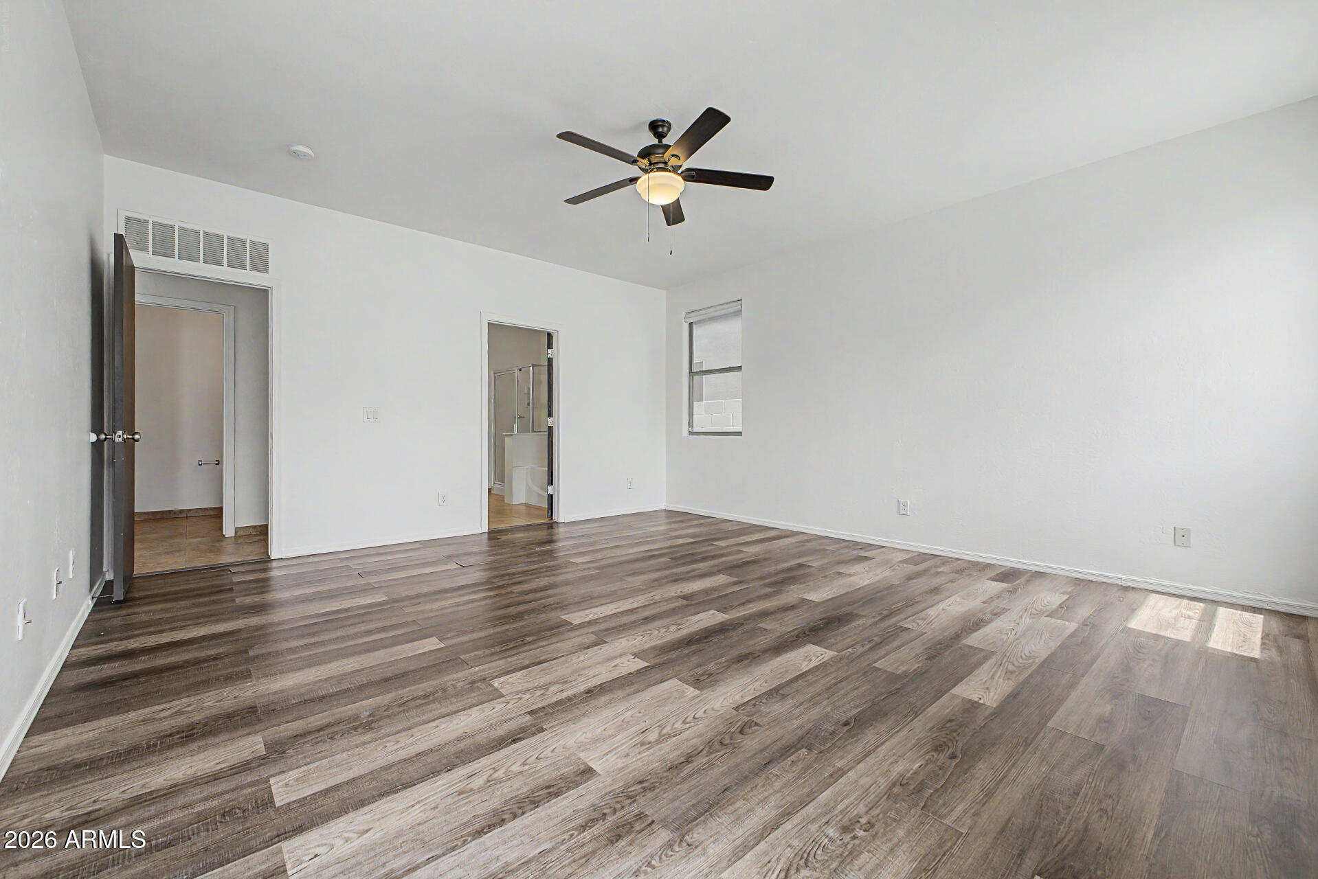 45571 West Tucker Road Maricopa, AZ 85139 - Photo 23 of 61 a view of empty room with wooden floor and ceiling fan