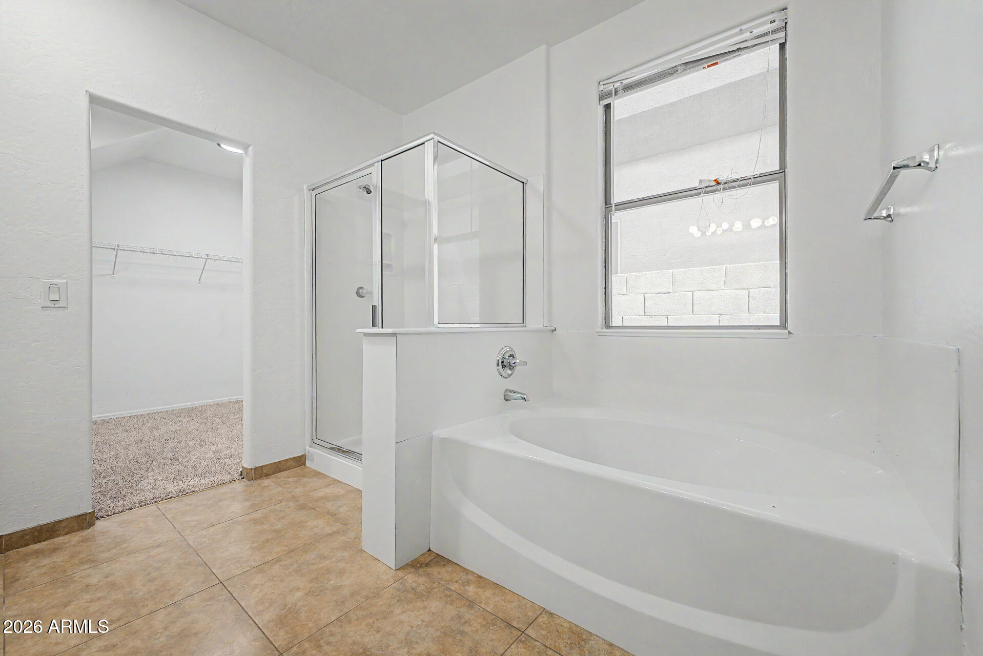 45571 West Tucker Road Maricopa, AZ 85139 - Photo 27 of 61 a spacious bathroom with a bathtub and a shower