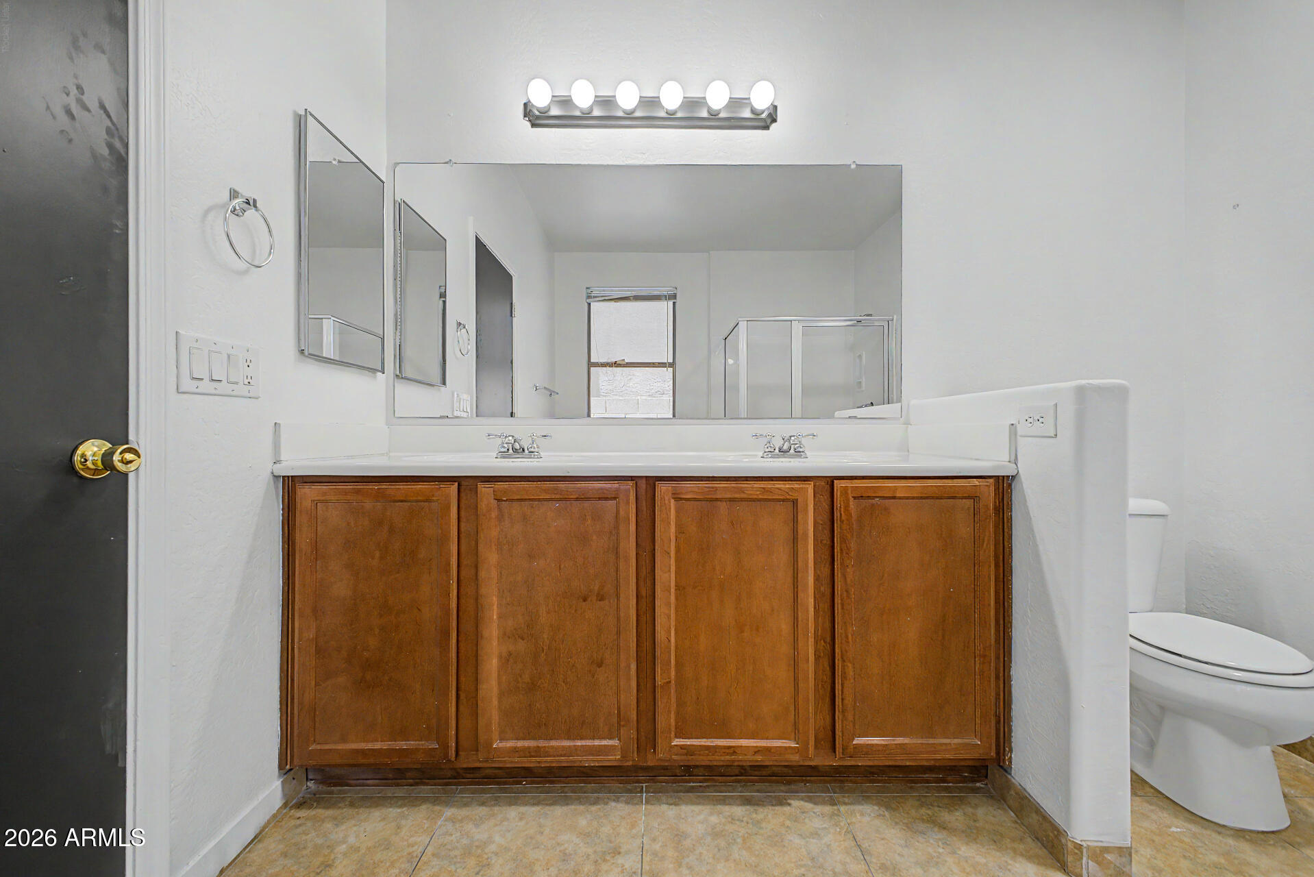45571 West Tucker Road Maricopa, AZ 85139 - Photo 29 of 61 a bathroom with a granite countertop sink a mirror and a toilet