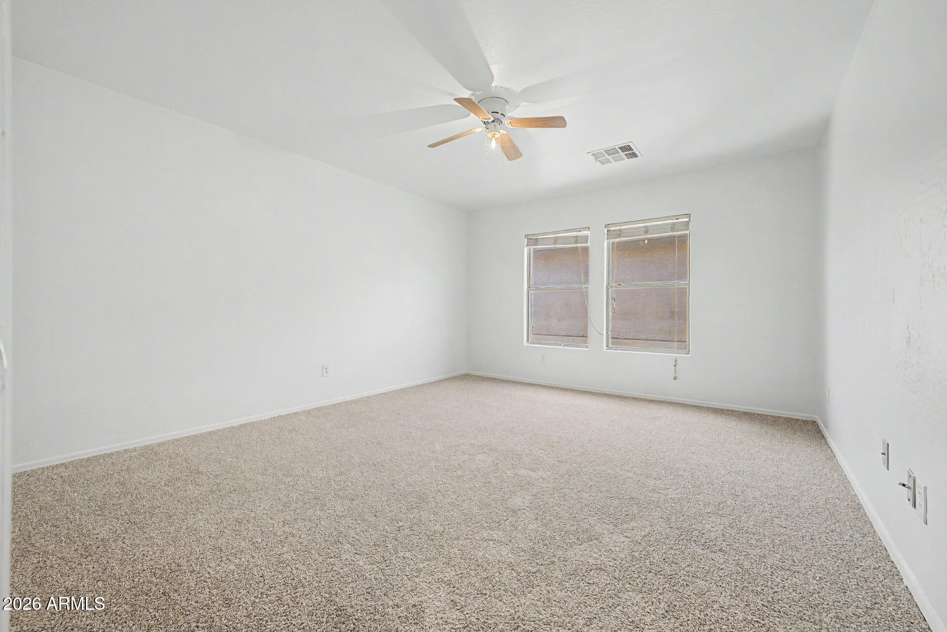 45571 West Tucker Road Maricopa, AZ 85139 - Photo 32 of 61 an empty room with a ceiling fan and window