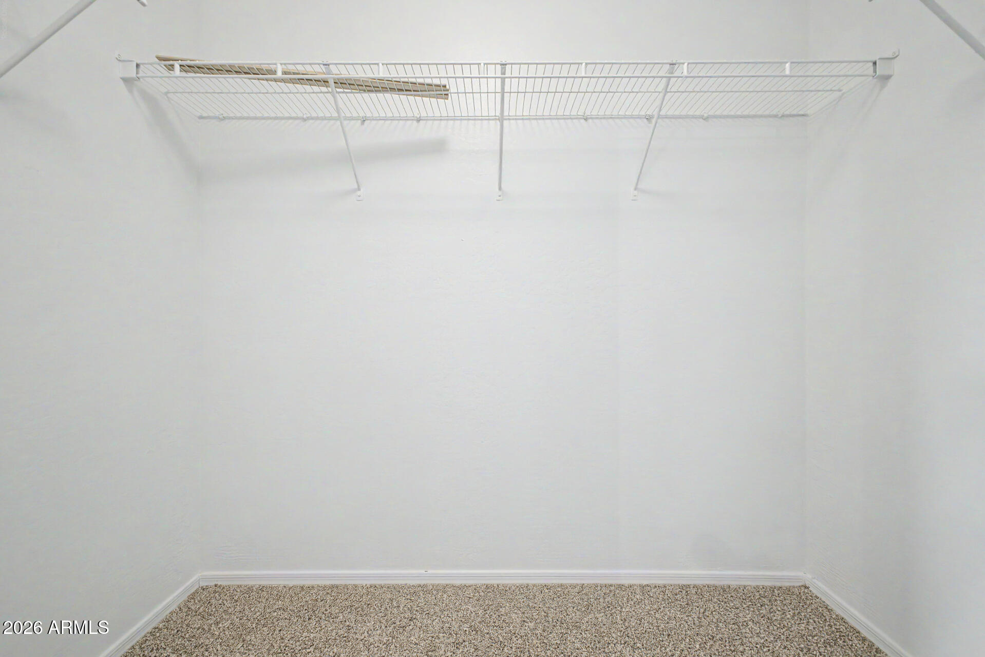 45571 West Tucker Road Maricopa, AZ 85139 - Photo 36 of 61 a view of a room with racks on the wall