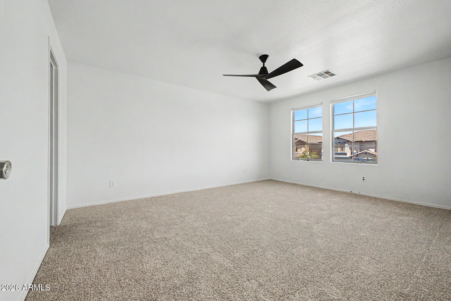 45571 West Tucker Road Maricopa, AZ 85139 - Photo 37 of 61 an empty room with windows & ceiling fan view