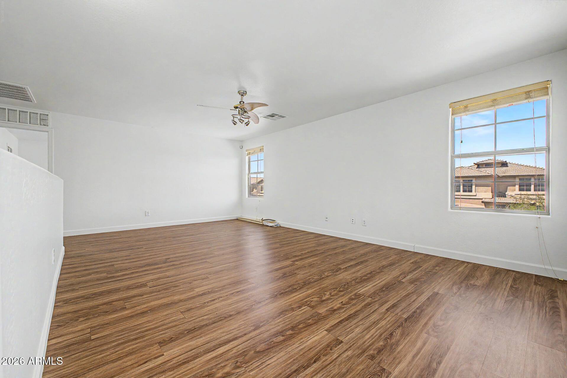 45571 West Tucker Road Maricopa, AZ 85139 - Photo 46 of 61 a view of an empty room with wooden floor and a window