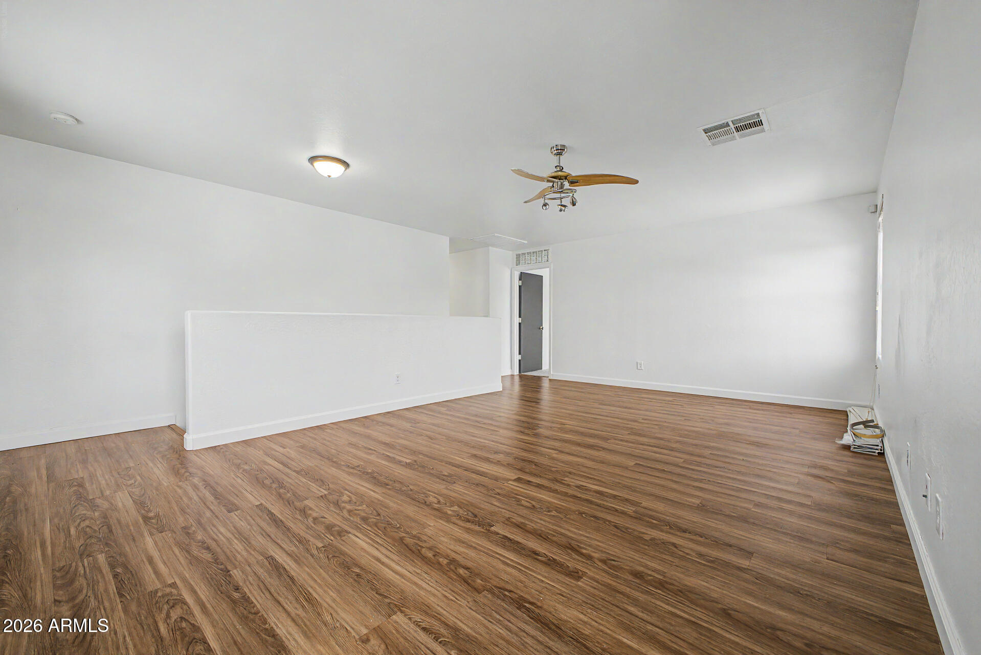 45571 West Tucker Road Maricopa, AZ 85139 - Photo 47 of 61 a view of an empty room with wooden floor