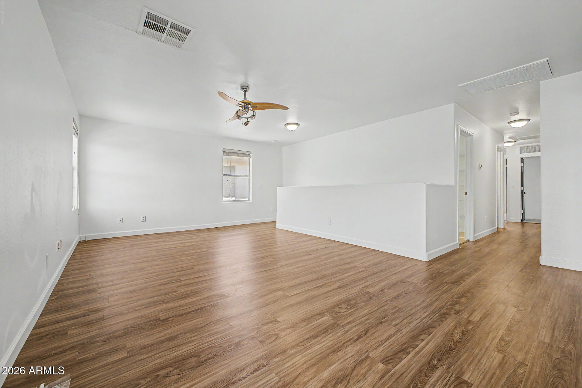 45571 West Tucker Road Maricopa, AZ 85139 - Photo 48 of 61 a view of an empty room with wooden floor and a window