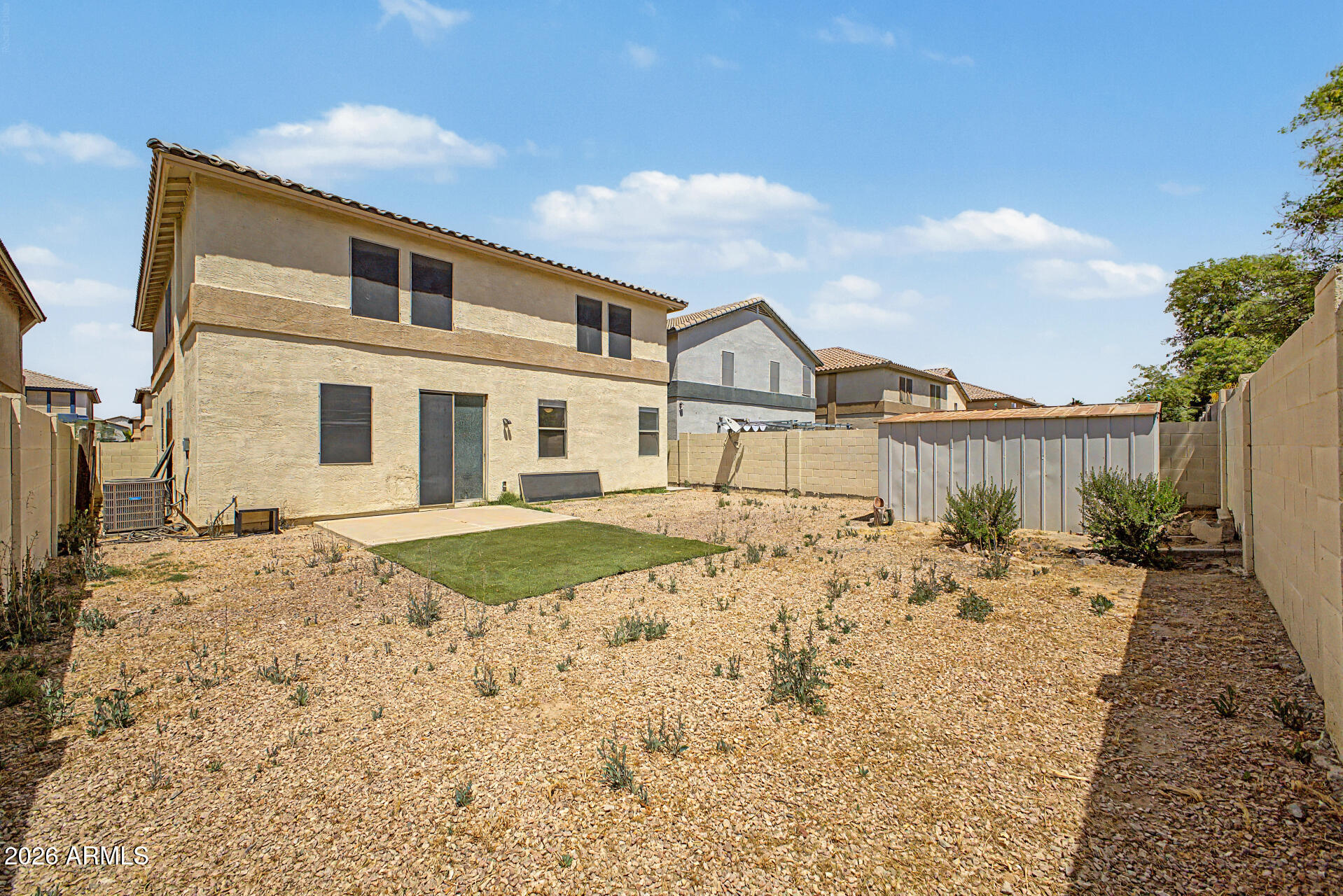 45571 West Tucker Road Maricopa, AZ 85139 - Photo 55 of 61 a front view of a house with a dirt yard and a garage
