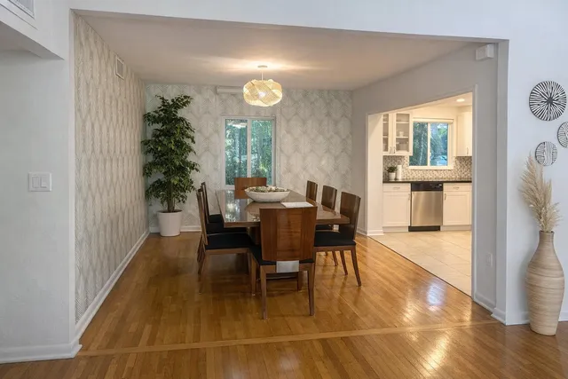 a view of a dining room with furniture and wooden floor