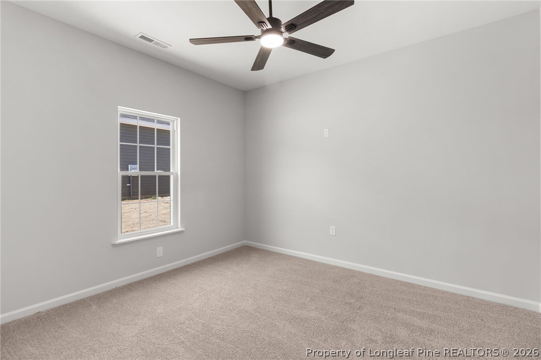 802 Holmes Street Clinton, NC 28328 - Photo 21 of 31 an empty room with a window and ceiling fan