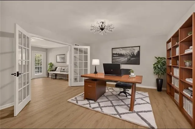 a living room with furniture a piano and a bookshelf