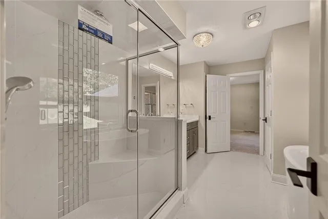 a bathroom with a shower and a sink