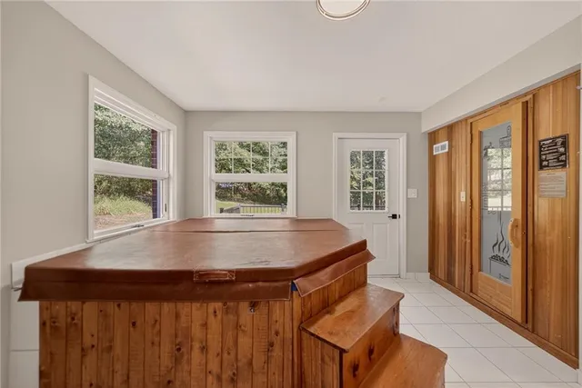 a room with pool table and windows