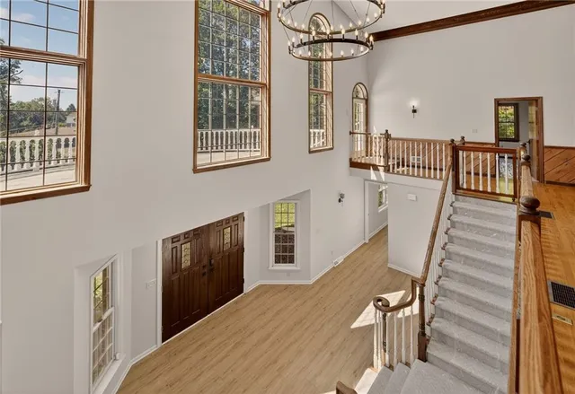 a view of a livingroom with wooden floor and stairs