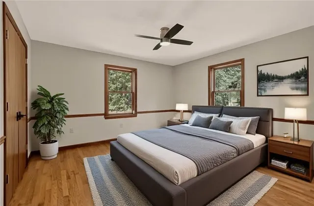 a bedroom with bed and a potted plant