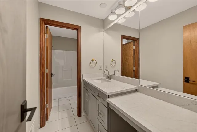 a bathroom with a sink a vanity and a mirror