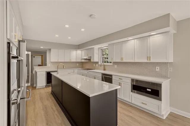 a kitchen with a sink stove and cabinets
