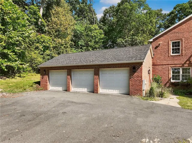 a view of a house with a yard and garage