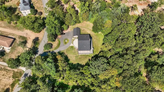 an aerial view of a house with a yard and garden
