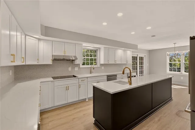 a kitchen with a sink stove and cabinets