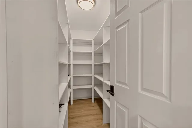 a view of walk in closet with empty racks