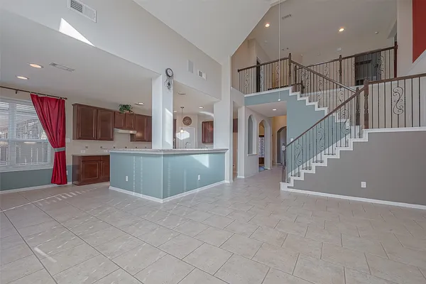 a kitchen with stainless steel appliances kitchen island granite countertop a refrigerator and a sink