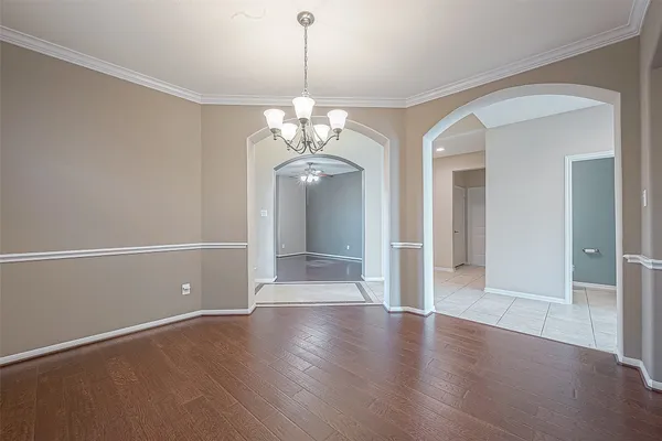 a view of a room with wooden floor and a window