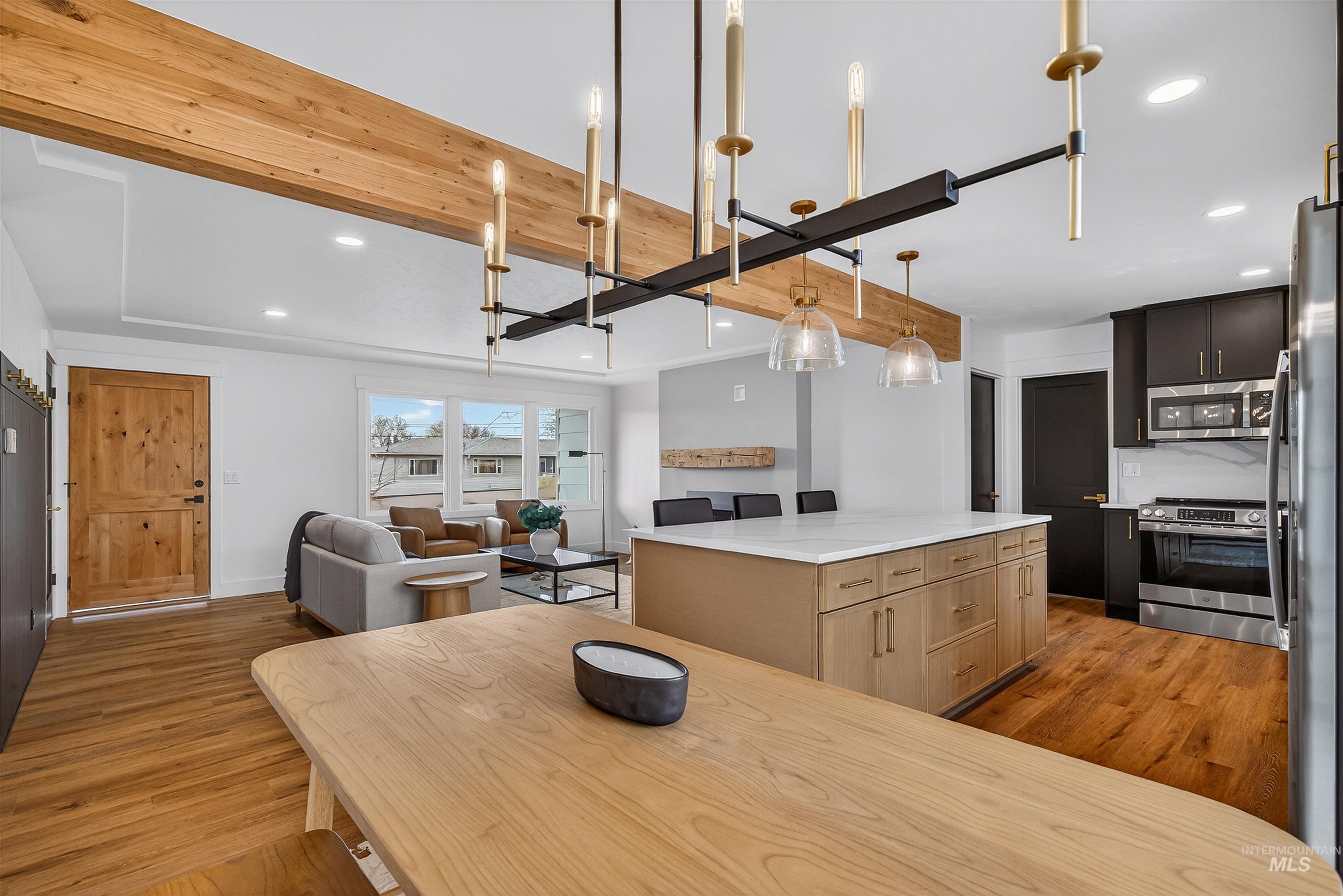 3513 8th Street Lewiston, ID 83501 - Photo 41 of 41 Dual tone kitchen featuring a center island, stainless steel appliances, light wood-style floors, open floor plan, and two tone cabinets
