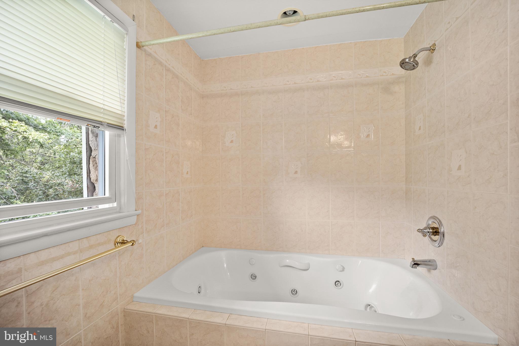 417 Gribbel Road Wyncote, PA 19095 - Photo 21 of 44 a white bath tub and shower in a bathroom