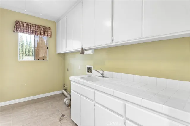 a view of a swimming pool with a patio and a garden