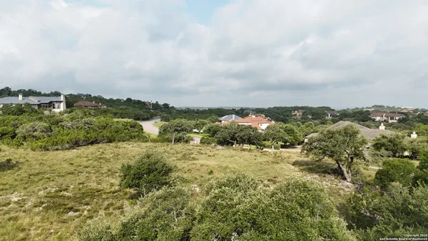 an aerial view of houses covered in trees