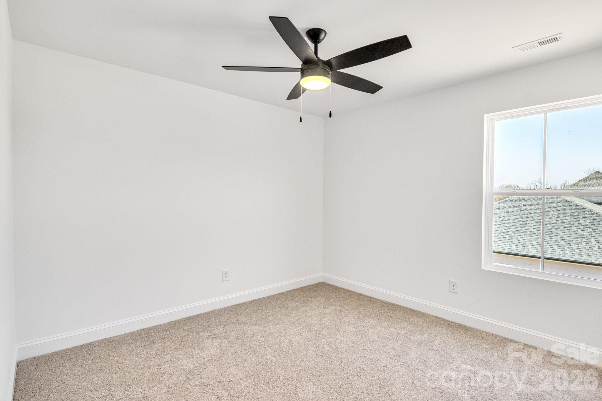 1335 Winged Way, Unit 4 Kannapolis, NC 28083 - Photo 19 of 29 an empty room with a window and a ceiling fan