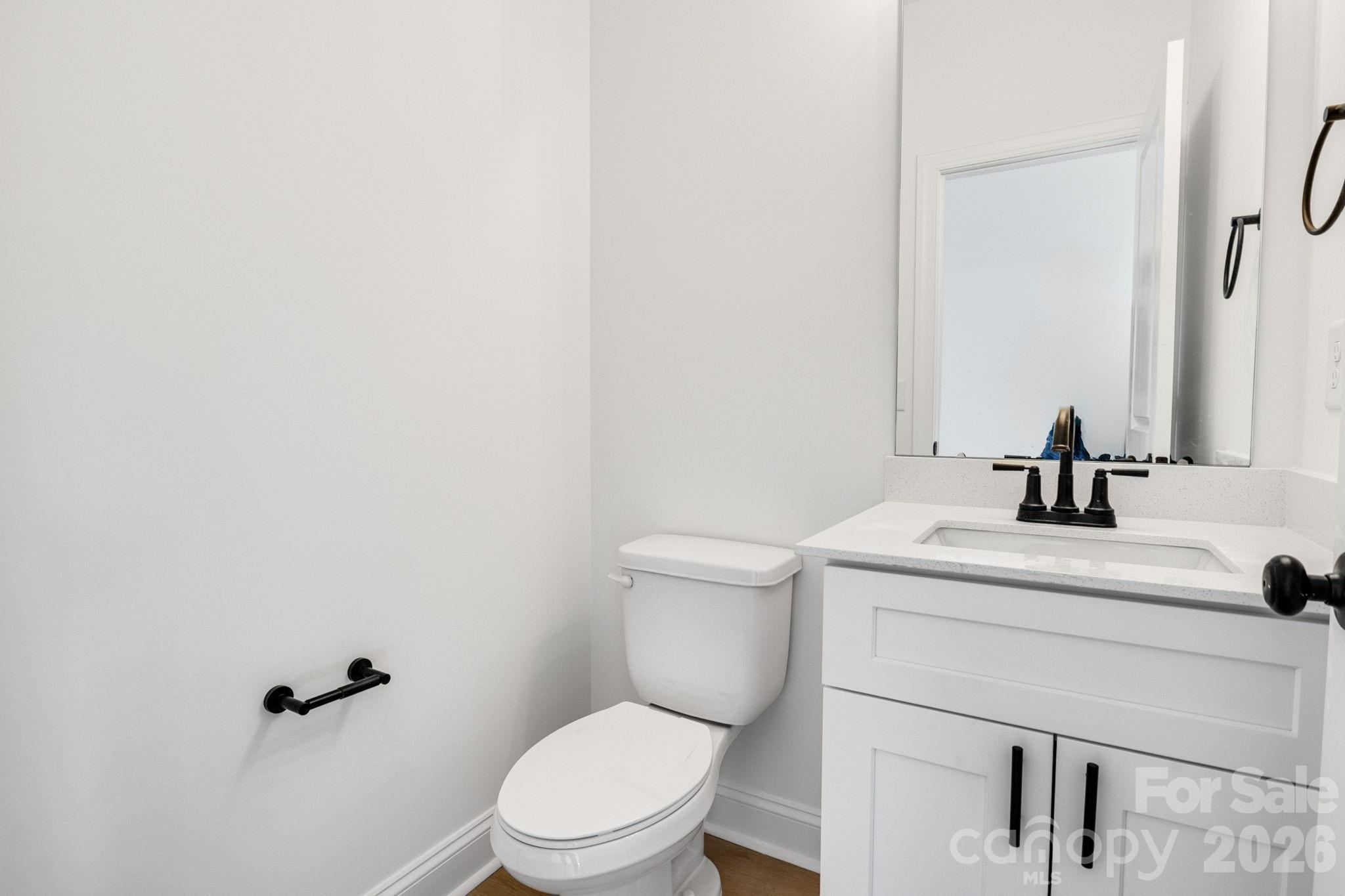 1335 Winged Way, Unit 4 Kannapolis, NC 28083 - Photo 28 of 29 a bathroom with a toilet a sink and mirror