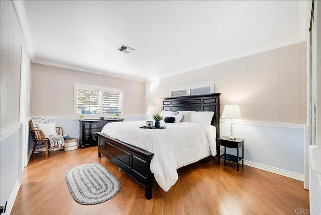 a bed room with a bed and a chair