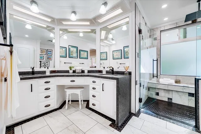 a bathroom with a double vanity sink mirror and toilet