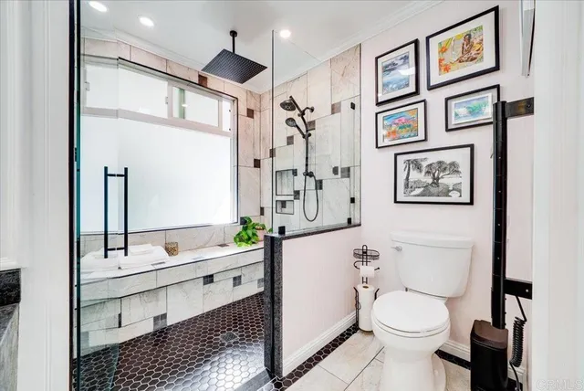 a bathroom with a sink a toilet and shower