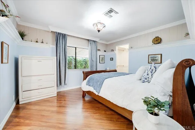 a bedroom with a bed and a potted plant