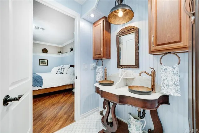 a bathroom with a sink mirror and vanity