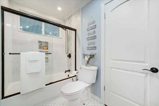 a bathroom with a granite countertop toilet a sink and shower