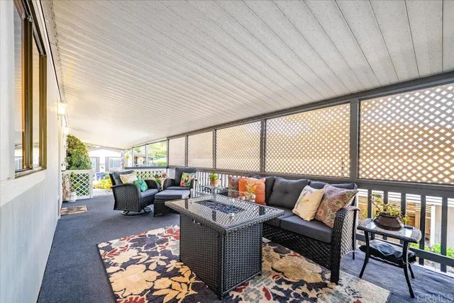 a living room with furniture and large windows