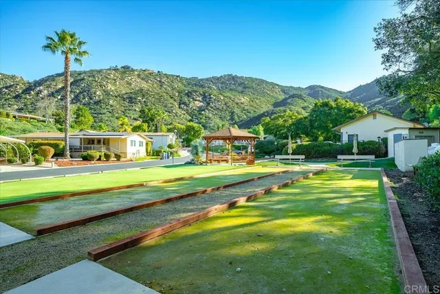 an aerial view of residential houses with outdoor space and swimming pool