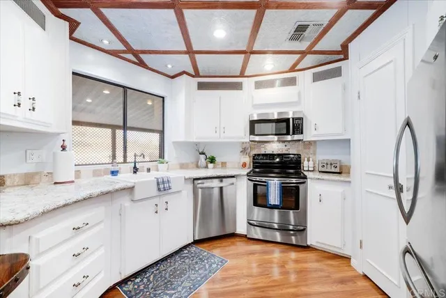 a kitchen with a sink appliances and cabinets