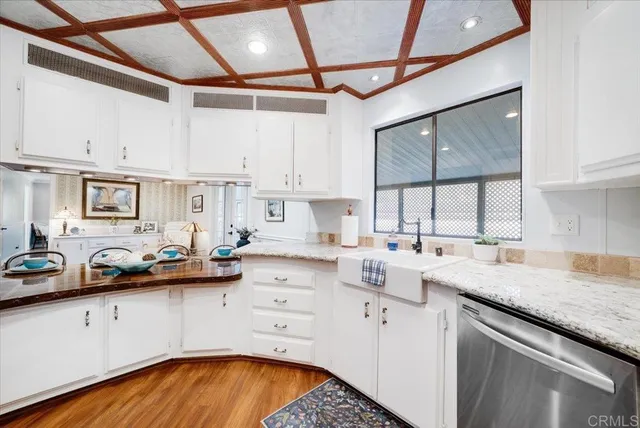 a kitchen with a sink a stove and cabinets