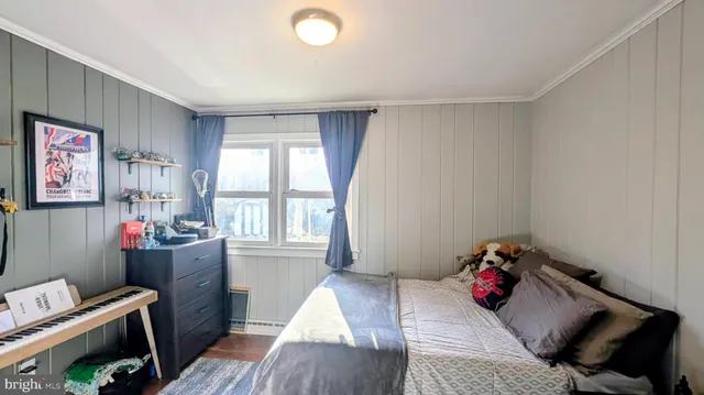 a bedroom with furniture and a window