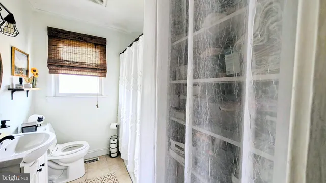 a bathroom with a toilet sink and shower