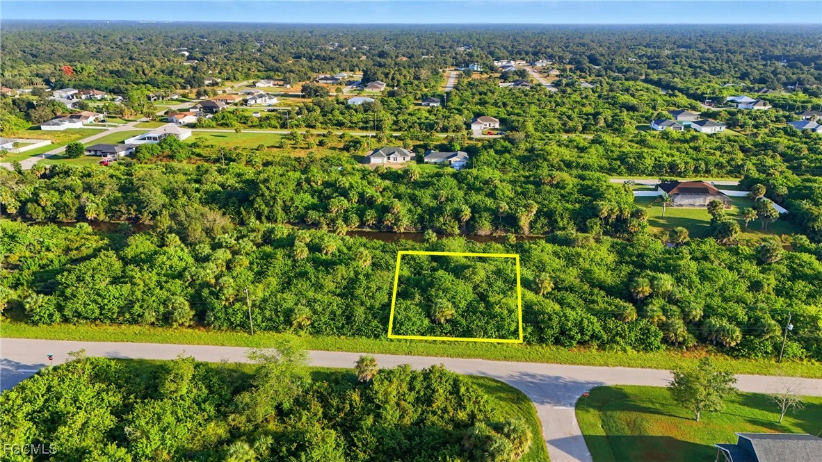 346 Rutland Circle Port Charlotte, FL 33954 - Photo 4 of 22 a view of a city with lush green forest