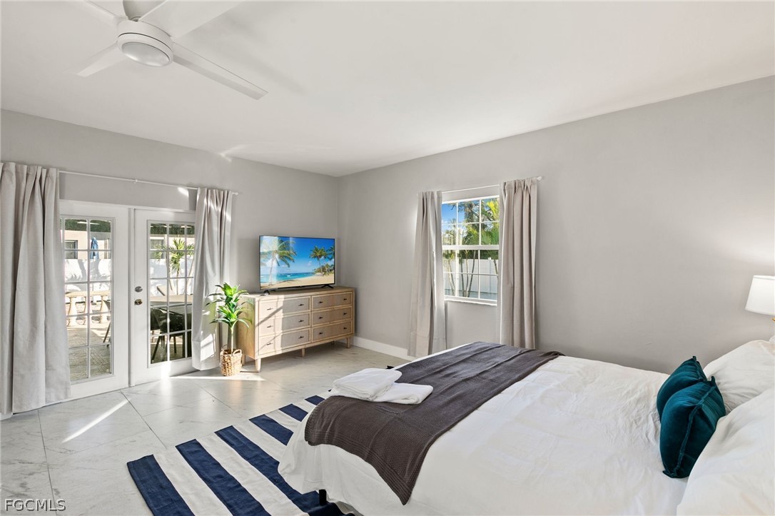317 3rd Avenue Marco Island, FL 34145 - Photo 12 of 29 a bedroom with a bed and glass door