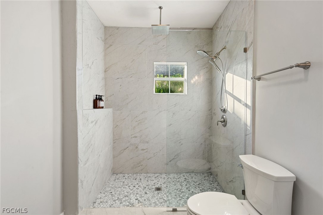 317 3rd Avenue Marco Island, FL 34145 - Photo 14 of 29 a bathroom with a shower a toilet and a sink