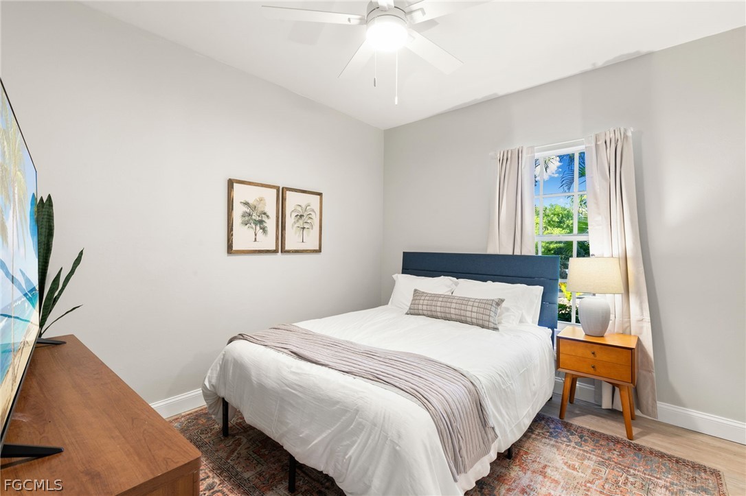 317 3rd Avenue Marco Island, FL 34145 - Photo 15 of 29 a bedroom with a bed and a potted plant
